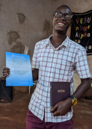 Vianney With His Certificate And Bible