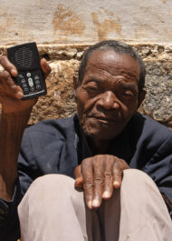 Portrait Of 95 Year Old Gabrielah Holding His Cherished Audio Bible.